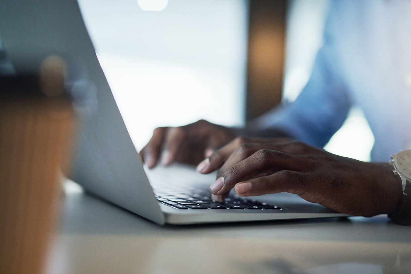 Close-up of a hand typing on a keyboard, possibly during preparations for shareholders and proxy meetings.